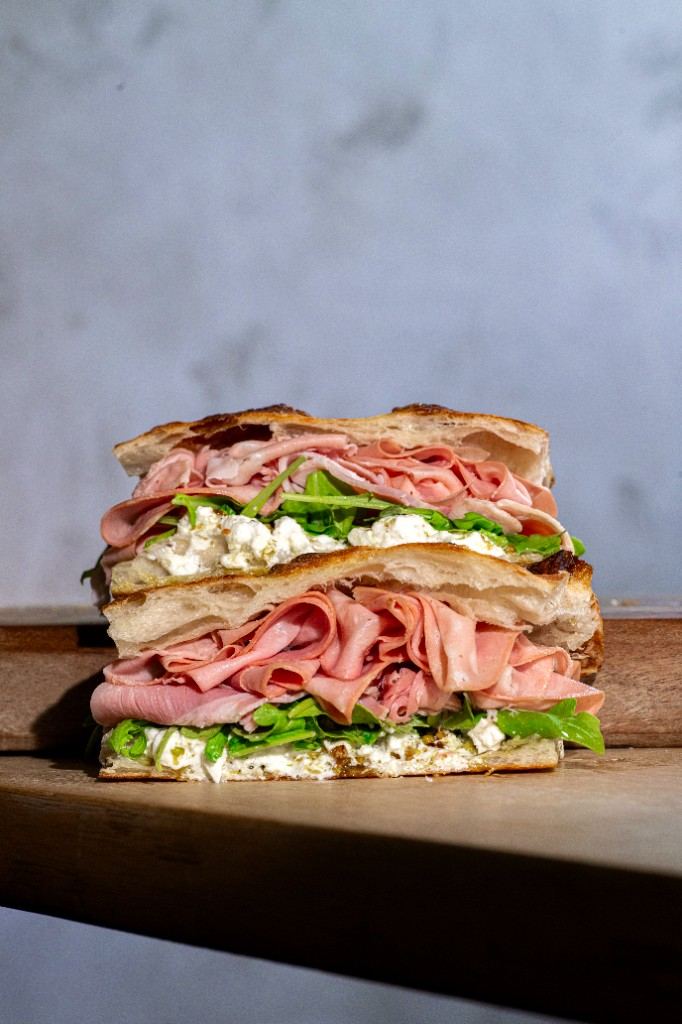 Stacked focaccia sandwich with mortadella and stracciatella