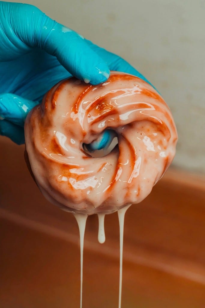 A glazed cruller dripping with vanilla glaze at Penelope Bakehouse