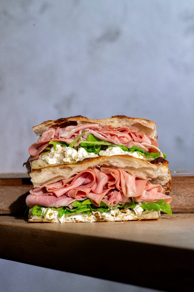 Stacked focaccia sandwich with mortadella and stracciatella