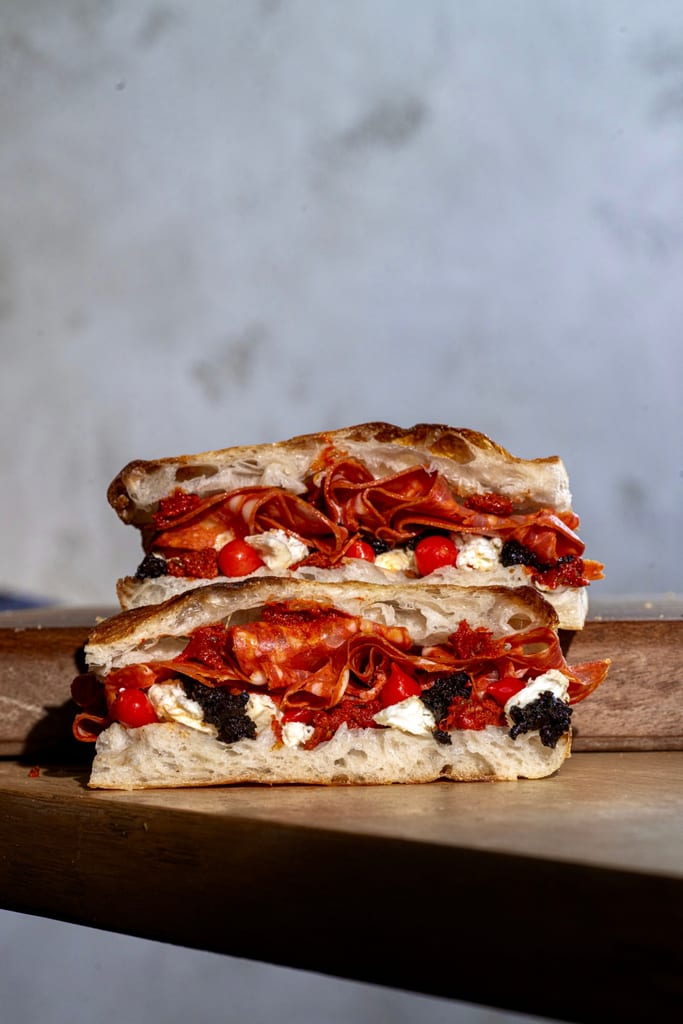 Calabrese focaccia sandwich with hot soppressata, fior di latte and black olives